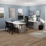 A cozy home office featuring blue walls and warm wood floors, creating a serene and inviting workspace atmosphere.