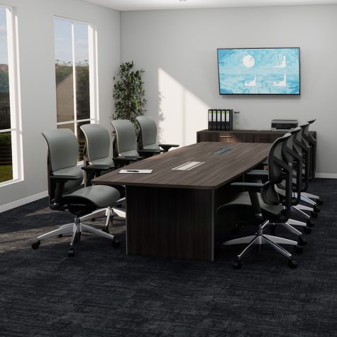 A conference table surrounded by chairs, featuring a flat screen TV mounted on the wall.