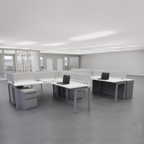 A spacious open office featuring multiple desks and chairs arranged for collaborative work.